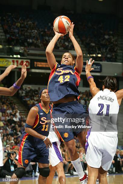 Nykesha Sales of the Connecticut Sun drives to the basket around Ticha Penicheiro of the Sacramento Monarchs during Game 3 of the WNBA Finals on...