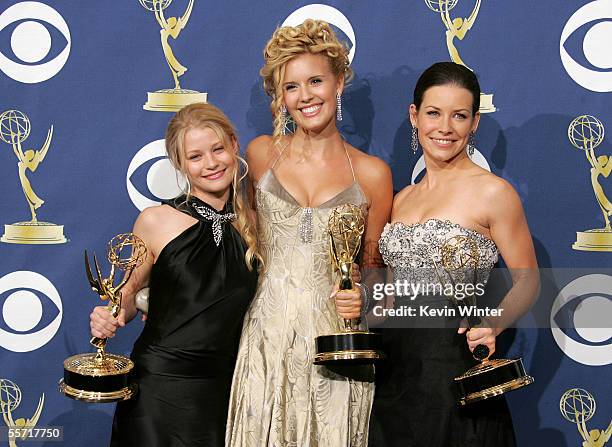 Lost' actresses Emilie de Ravin, Maggie Grace and Evangeline Lilly pose with the Emmy for Outstanding Drama Series in the press room at the 57th...