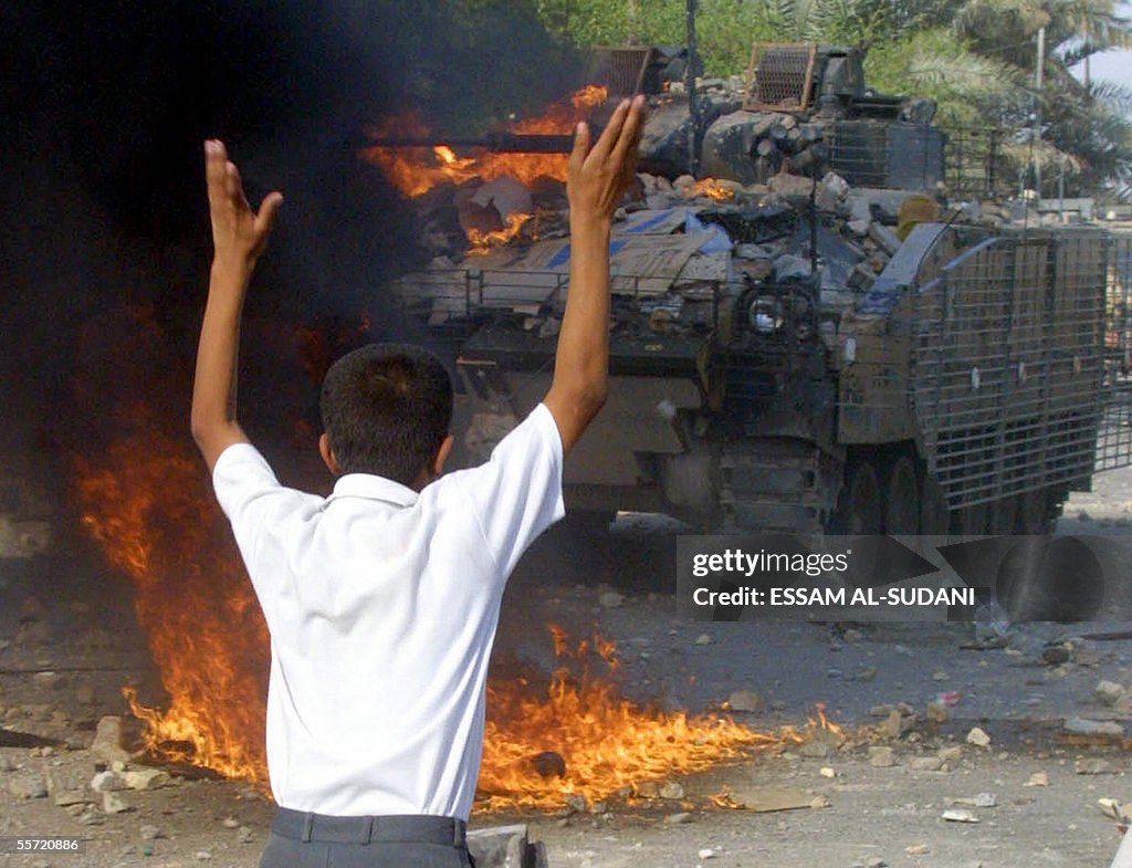 An Iraqi protester waves in front of a B
