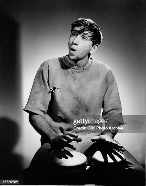 American actor Bob Denver plays the bongos as he poses in character as Maynard G. Krebs the Beatnik from the televison situation comedy 'The Many...