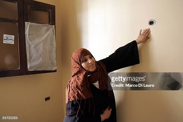 Nadia Al-Shair, 40-years-old, points to a bullet hole in a wall of her house on September 19, 2005 in Rafah refugee camp, Gaza Strip. Nadia and her...