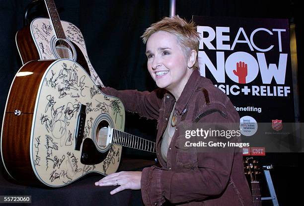 Musician Melissa Etheridge signs a Gibson guitar backstage at the "ReAct Now: Music & Relief" benefit concert at Paramount Studios on September 10,...