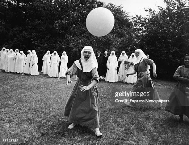 Group of nuns play basketball outdoors at the Ladywell Convent, Godalming, England, August 2, 1965.