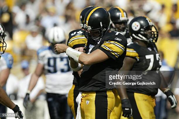 Quarterback Ben Roethlisberger of the Pittsburgh Steelers looks at a list of plays taped to his wrist during a game against the Tennessee Titans at...