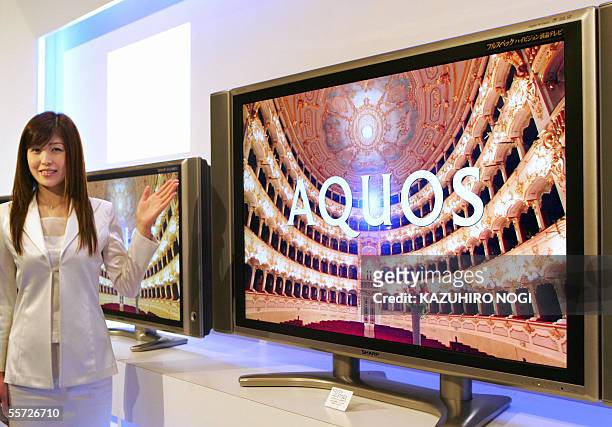 Model displays a new 57V-inch full-spec high-definition LCD TV 'AQUOS LC-57GE2' presented by Japan's Sharp Corporation during a press preview at a...