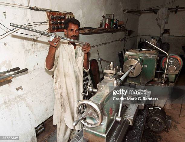 Pashtun tribal man shows off his arms parts he has made on August 9, 2005 in Darra Adam Khel, Pakistan. The Afridi of Darra Adam Khel clan is the...