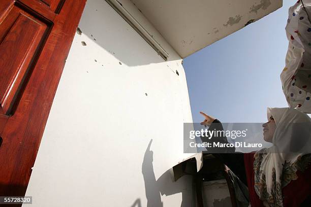 Rewaida Azam, 23-years-old, gestures as she points tyo bullet holes on a wall of her house on September 20, 2005 in Al Moghraka on the edge of the...