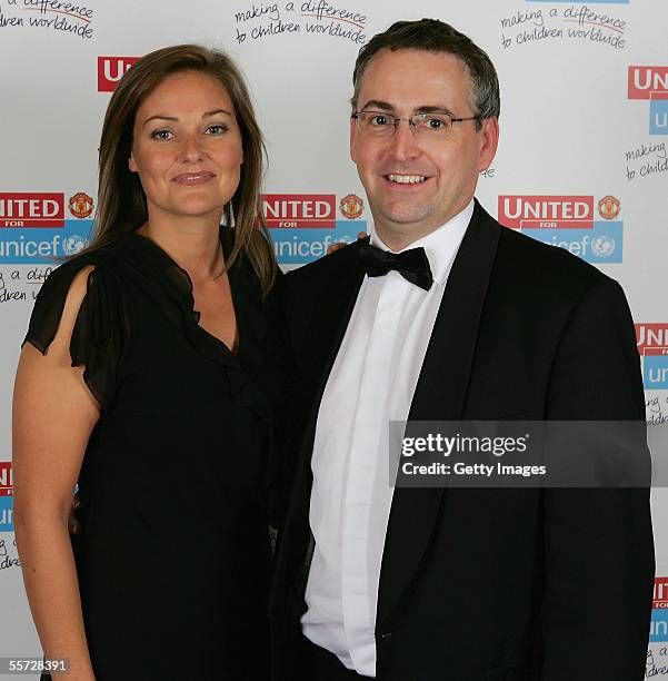 Claire Tomlinson presents an auction winner with his prize at the annual United for Unicef charity dinner September 19, 2005 in Manchester, England....