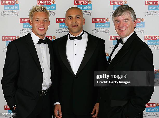 Alan Smith of Manchester United presents an auction winner with his prize at the annual United for Unicef charity dinner September 19, 2005 in...