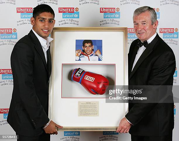 Amir Khan presents an auction winner with his prize at the annual United for Unicef charity dinner September 19 2005 in Manchester, England. Sir Alex...