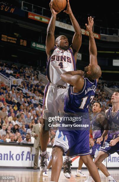 Forward Alton Ford of the Phoenix Suns shoots the ball over center John Amaechi of the Utah Jazz during the NBA game at the American Airlines Arena...