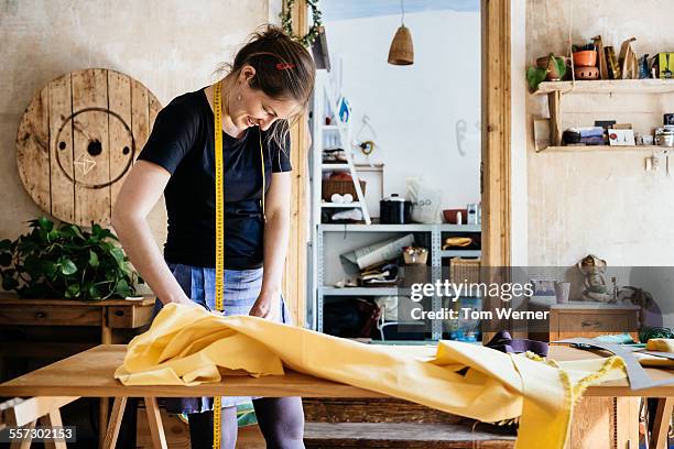 Seamstress With Fabric In Her Workshop