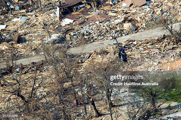 Sheriff's helicopter patrols over homes that lay in ruins after being destroyed by the tidal surge caused by Hurricane Katrina on the southern...