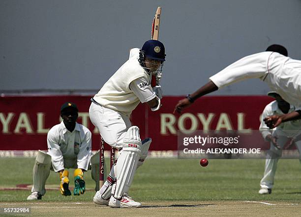 India's Saurav Ganguly plays a shot as Zimbabwe's Tatenda Taibu waits to make a catch 21 September 2005 on the second day of the second test in...