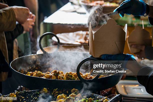 hot meal in borough market - borough market stock pictures, royalty-free photos & images