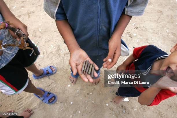 Adnan Mokhemar , 13-years-old, holds bullets thought to once belong to the Israelis while standing in front of his house on September 21, 2005 in the...