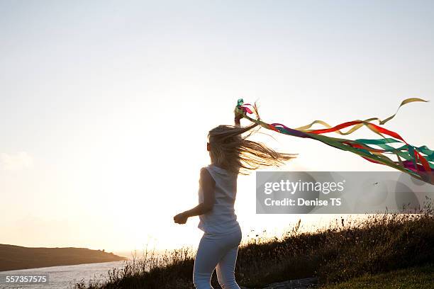 girl dancing with ribbons near the beach - children dancing outside stockfoto's en -beelden