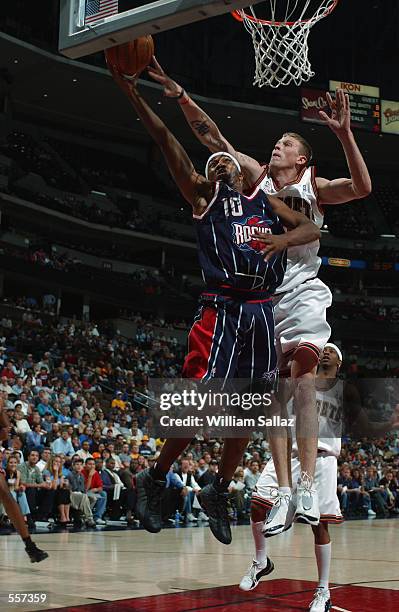 Guard Tierre Brown of the Houston Rockets shoots past center Chris Andersen of the Denver Nuggets during the NBA game at Pepsi Center in Denver,...