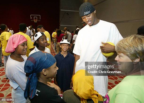 Rashard Lewis of the Seattle SuperSonics visits with young evacuees, who have been displaced due to the effects ofr Hurricane Katrina during Kenny...