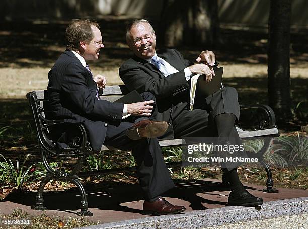 Secretary of Defense Donald Rumsfeld sits on a park bench with Eric Ruff, a Pentagon spokesman, while waiting to brief U.S. House members on...