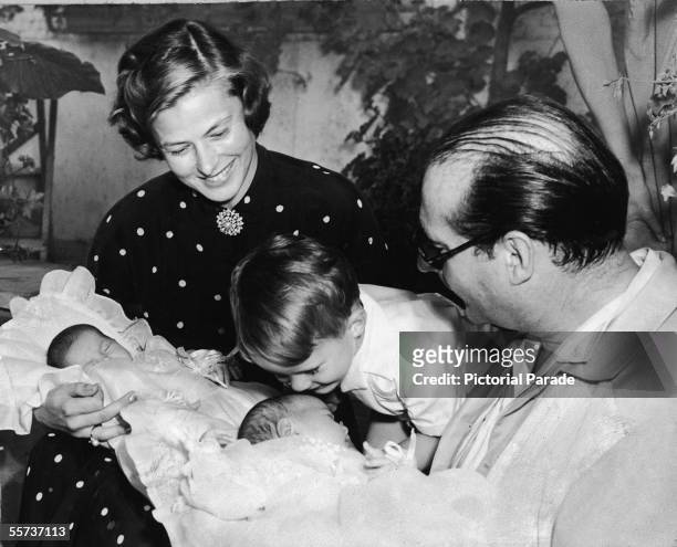 Swedish actress Ingrid Bergman and her second husband Italian motion picture director Roberto Rossellini holds their twin daughters Ingrid and...