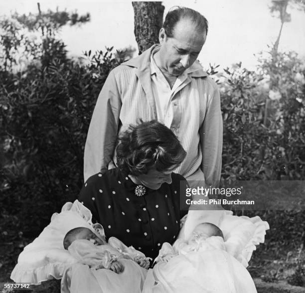 Italian motion picture director Roberto Rossellini looks over the shoulder of his second wife Swedish actress Ingrid Bergman at his two twin...