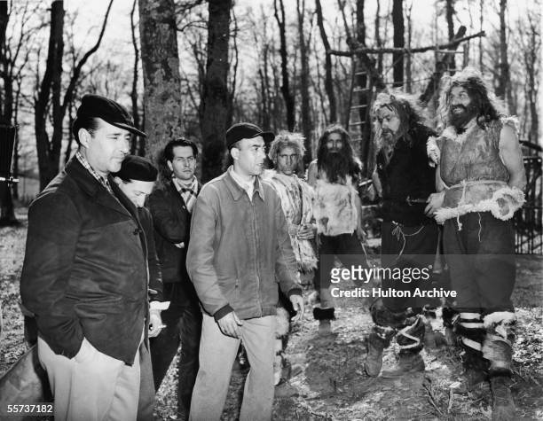 Italian motion picture director Roberto Rossellini and his assistants work with extras dressed as babrabarians on the set of Rossellini's movie about...