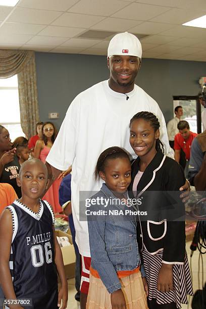 Jermaine O'Neal of the Indiana Pacers poses for a photo with evacuees, who have been displaced due to the effects of Hurricane Katrina, during Kenny...