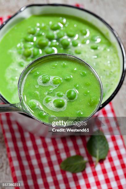 saucepan and dipper of pea soup - pea and mint soup stock pictures, royalty-free photos & images