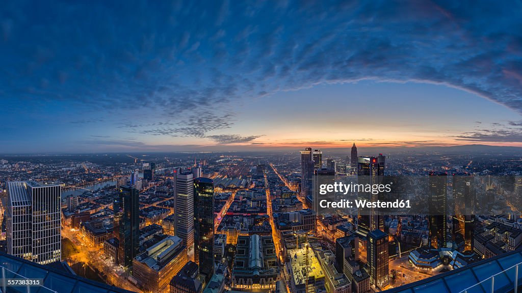 Germany, Frankfurt, View over the lighted city at sunset from above