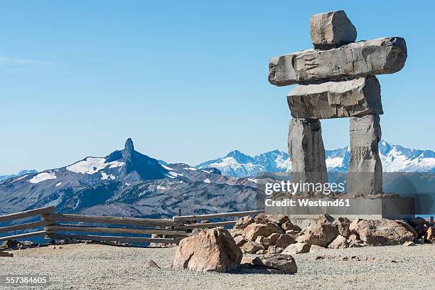 canada, british columbia, whistler, inuksuk on whistler mountain with black tusk in background - inukshuk stock pictures, royalty-free photos & images