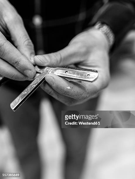 hairdresser's hand holding razor - straight razor stock pictures, royalty-free photos & images