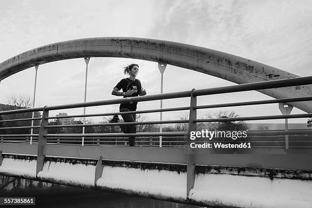 spain, gijon, woman jogging in the city - gijón fotografías e imágenes de stock