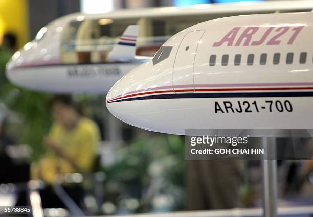 Models of the ARJ21 aircraft on display at the China Aviation Industry Corporation I booth during the Aviation Expo/China 2005 -- the 11th air expo...