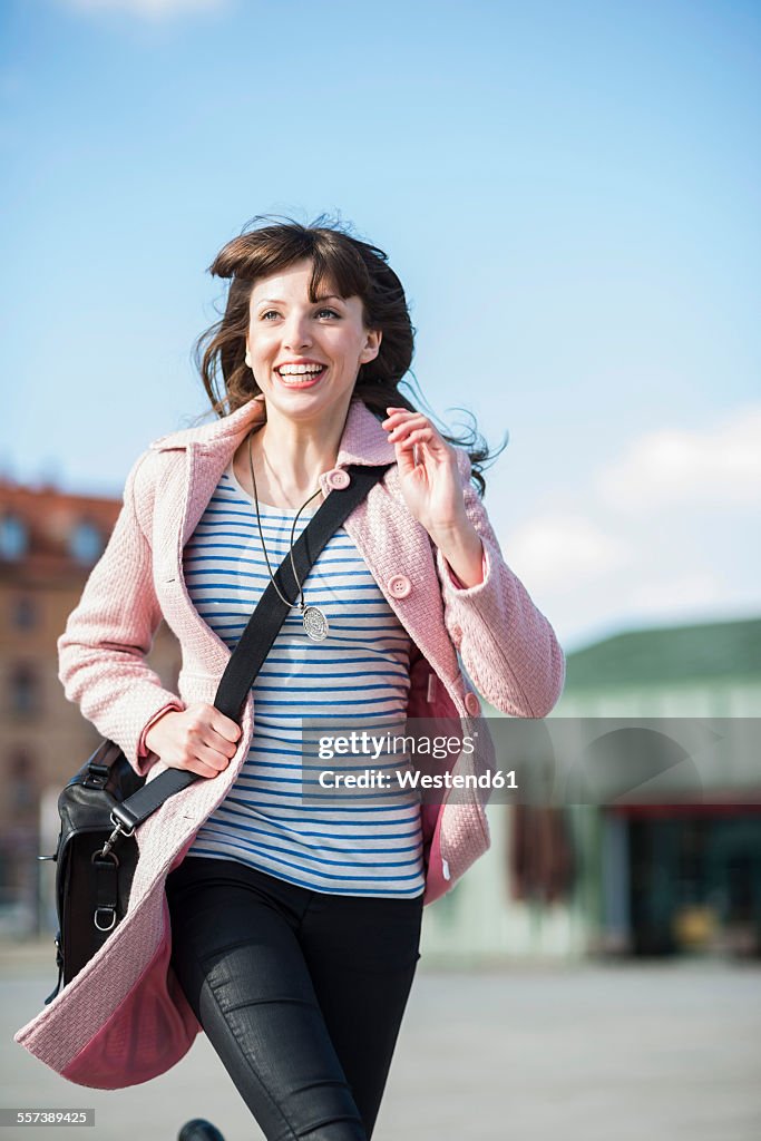 Young woman running in the street