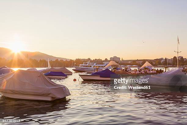 switzerland, zurich, lake zurich, seefeldquai, lounge on jetty at sunset - lake zurich stock pictures, royalty-free photos & images
