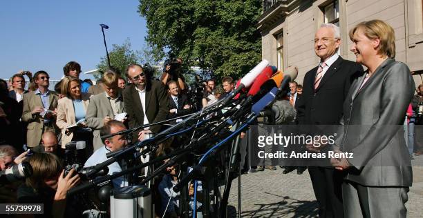 German chancellor candidate of the Christian Democratic Union Angela Merkel and Edmund Stoiber , governor of Bavaria and leader of the CSU, gesture...
