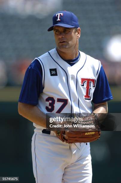 Pitcher Kenny Rogers of the Texas Rangers looks to the catcher for a sign during the game against the Minnesota Twins at Ameriquest Field in...