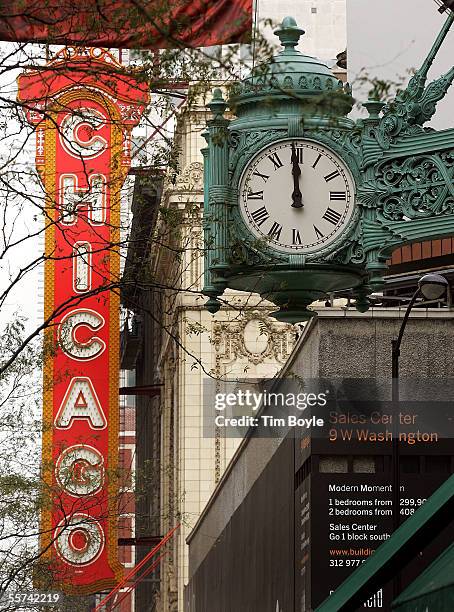 Signage from the Chicago Theater is seen beyond Marshall Field's famous clock outside the one-time flagship State Street store September 22, 2005 in...