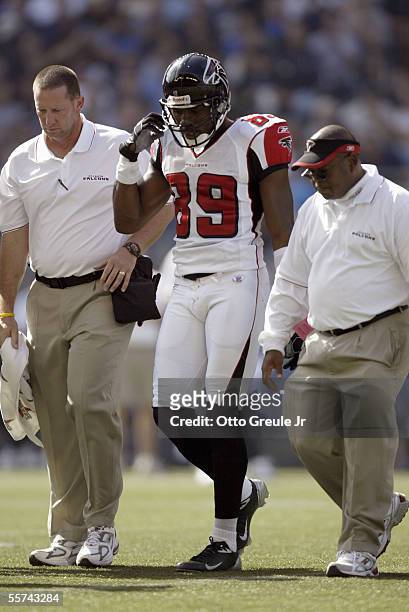 Head Athletic Trainer Ron Medlin and another Staff member of the Atlanta Falcons gets help to walk off the field Dez White during a game on Spetember...