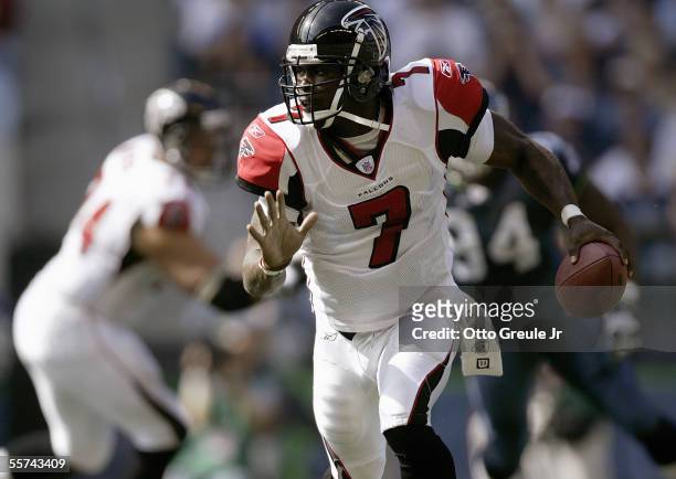Michael Vick of the Atlanta Falcons runs the ball for the play against the Seattle Seahawks during a game at Qwest Field on September 18, 2005 in...