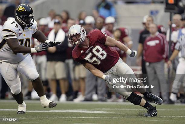 Defensive end Matt Mullennix of the Washington State University Cougars tries to get around offensive tackle Andre Bennett of the Grambling State...