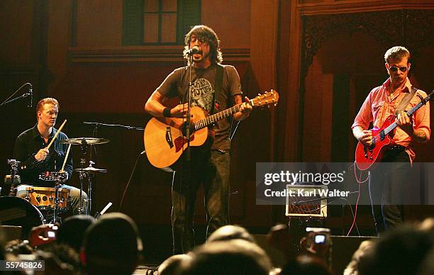 Musicians Josh Homme of Queens Of The Stone Age, Dave Grohl of The Foo Fighters and Jesse Hughes of The Eagles of Death Metal perform during the...