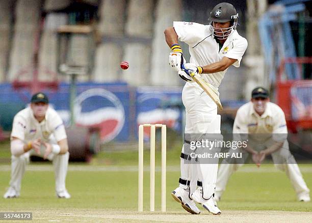 Pakistan 'A' cricketer Imran Farhat is watched by Australian 'A' team fielders as he plays a shot off his hips during the first one day match at the...