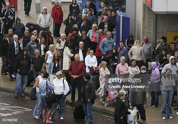 Passengers are evacuated from Terminal 1 as Manchester Airport is cordoned off after an incident between Terminals 1 and 2, on September 23, 2005 in...