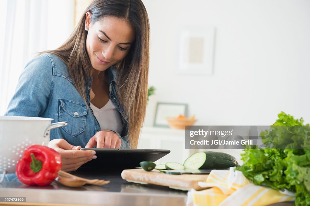 Caucasian woman using digital tablet for recipe