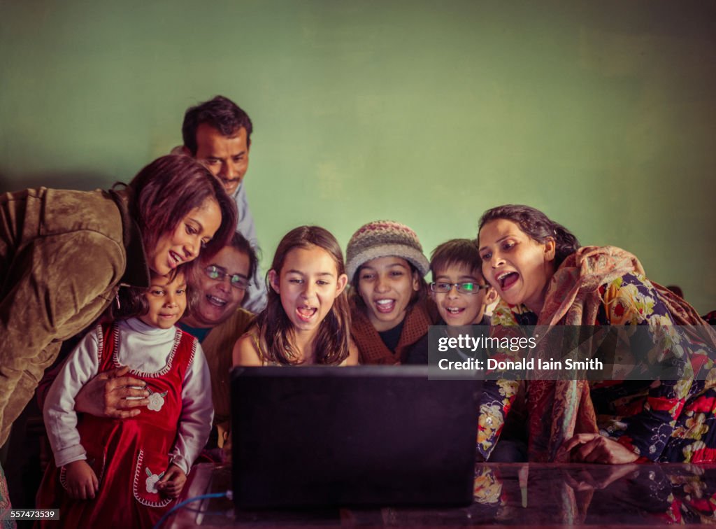 Multi-generation family videochatting on laptop