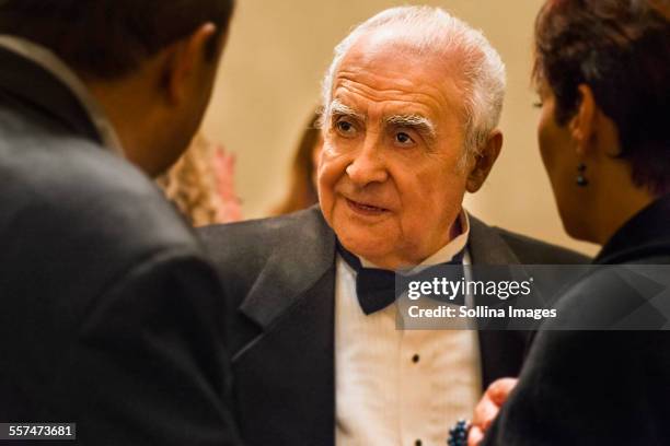 close up of older man talking to friends - tuxedo party stock pictures, royalty-free photos & images