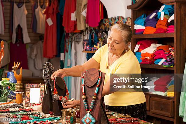 smiling woman working in traditional gift shop - gift shop stock pictures, royalty-free photos & images