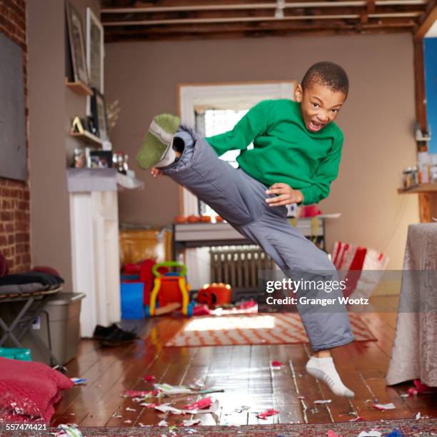 black boy doing karate kick in living room - karate stock pictures, royalty-free photos & images